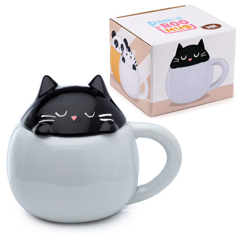 Adorable cat peeking from ceramic mug lid