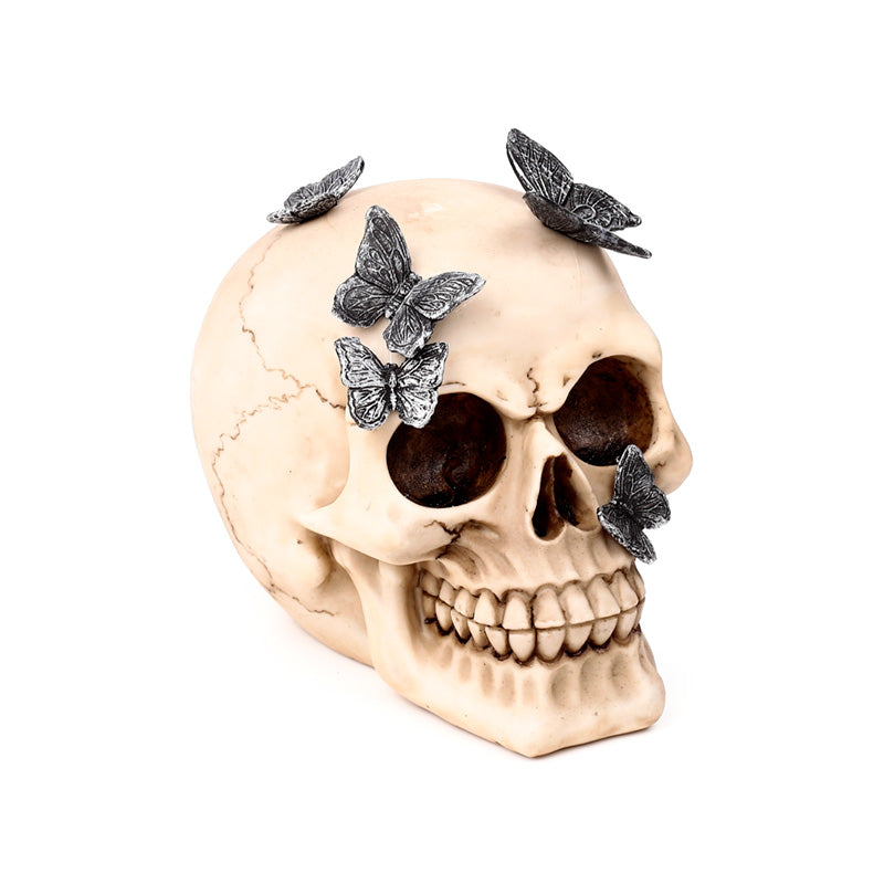 Decorative skull ornament with metallic butterflies