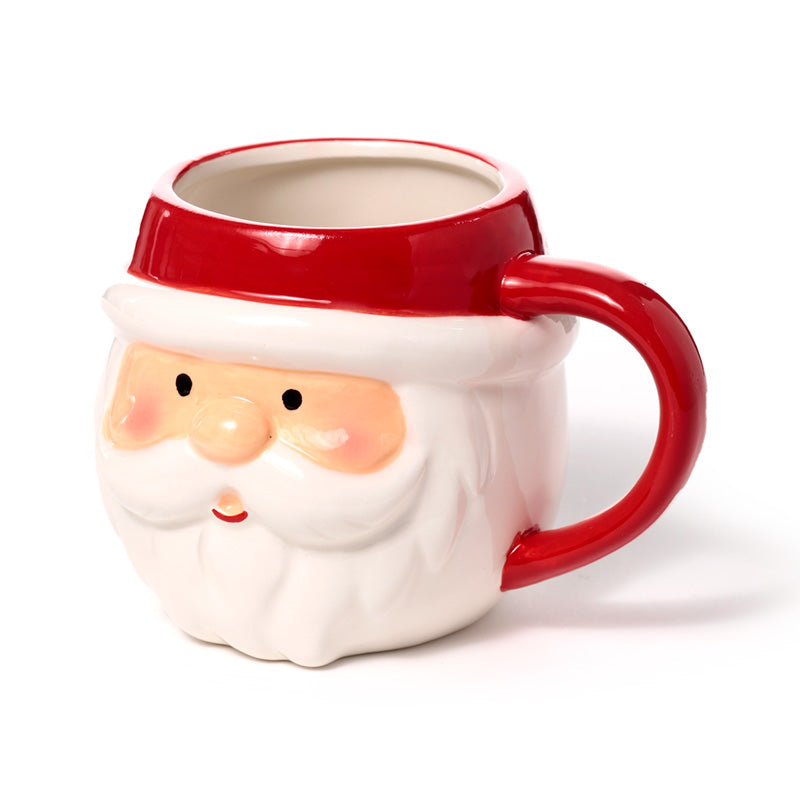 Ceramic Santa head mug displayed with holiday decorations
