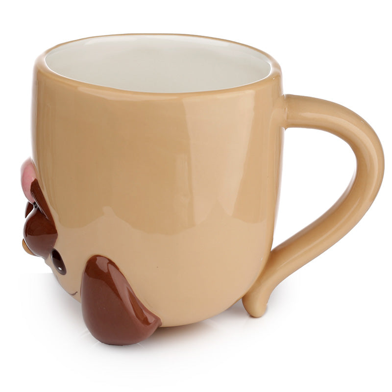 Mopps Pug ceramic mug displayed with decorative items