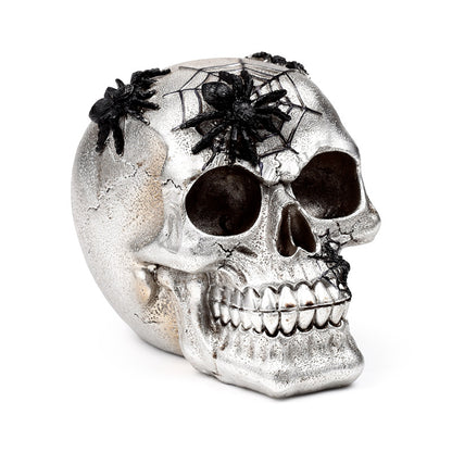 Silver skull decorative ornament with black spiders
