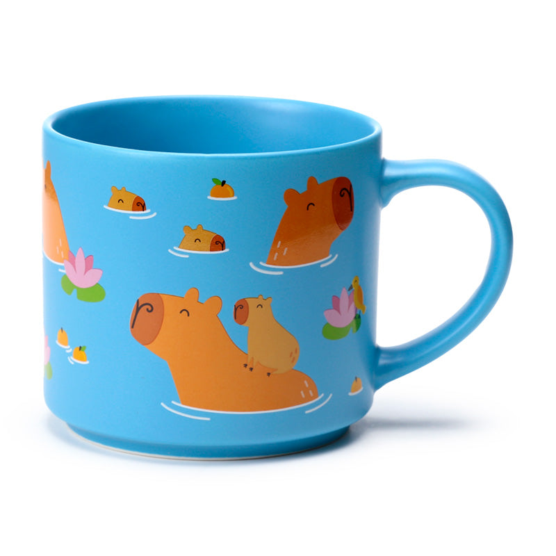 Cute capybara mug displayed with beverages