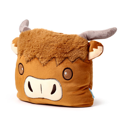 Highland Coo plush toy in a cozy setting