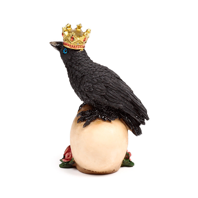 Crow wearing crown standing on skulls ornament
