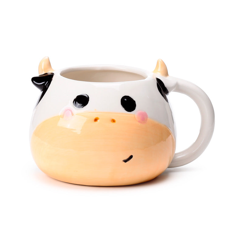 Close-up of black and white cow ceramic mug