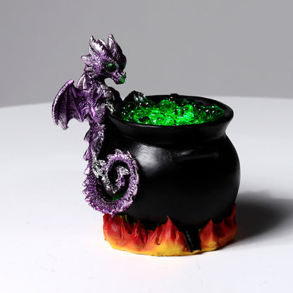 Close-up of the LED Dragon atop a bubbling cauldron
