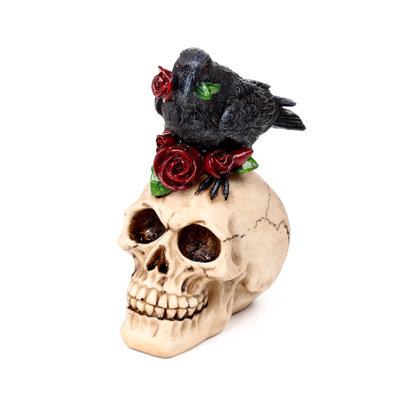 Raven on decorative skull with red roses