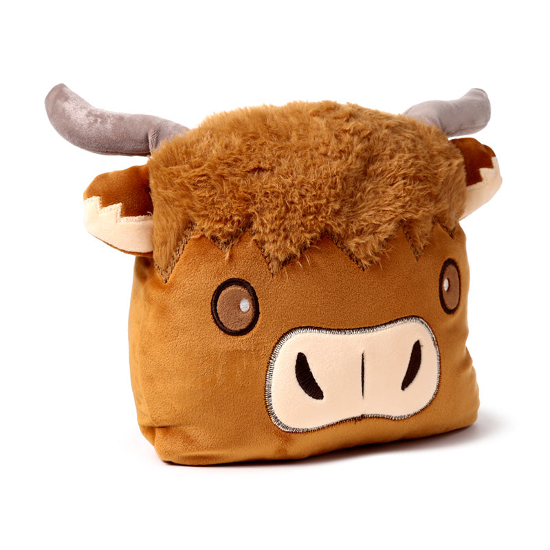 Highland Coo plush toy displayed with other decor