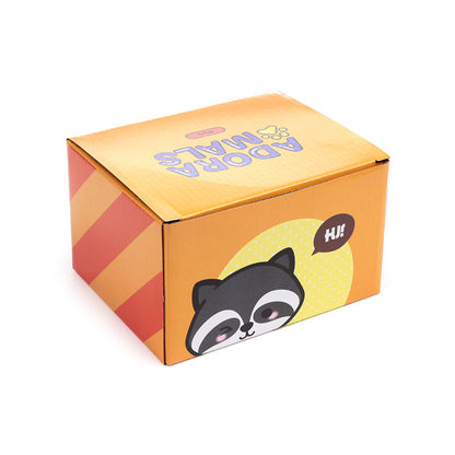 Ceramic mug featuring a playful raccoon design