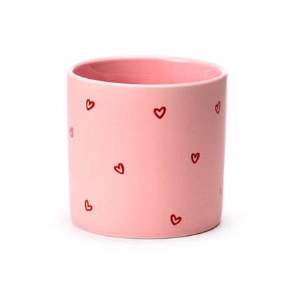 Amore Heart Shaped Handle Mug next to a book