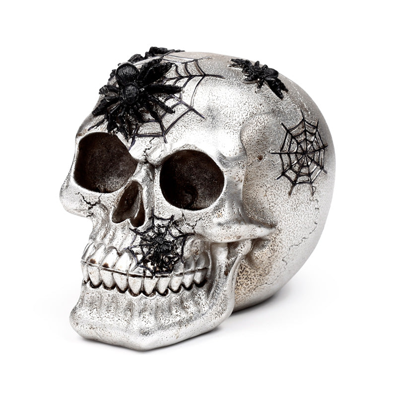 Decorative silver skull with intricate black spiders