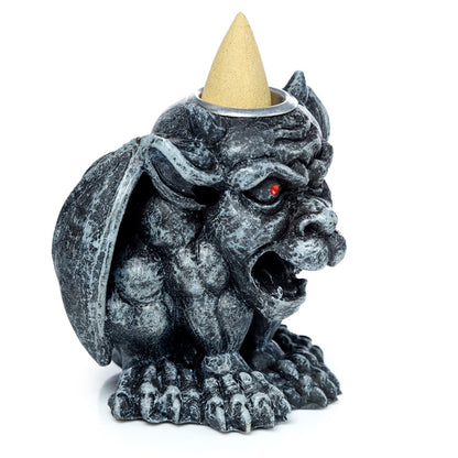 Decorative gargoyle incense burner in home setting