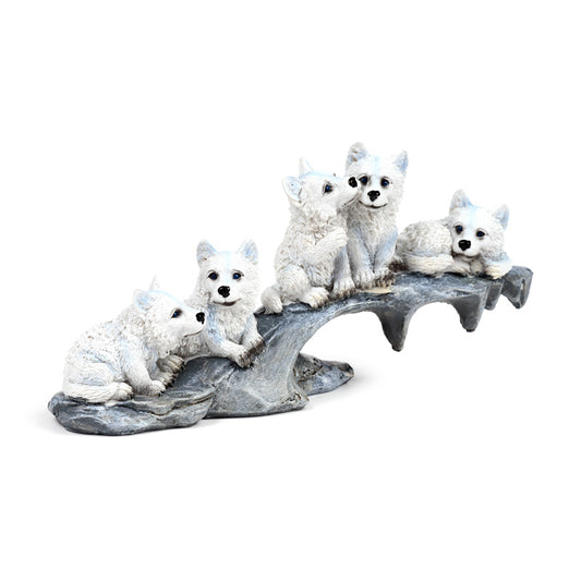 Wolf ornament with puppies playing on stone outcrop