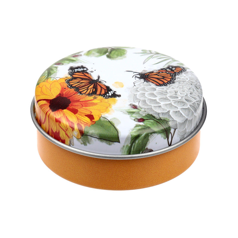 Butterfly Meadows Lip Balm with a nature-themed background