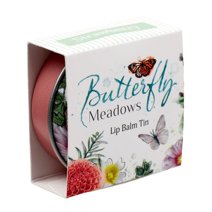 Butterfly Meadows Lip Balm surrounded by decorative items
