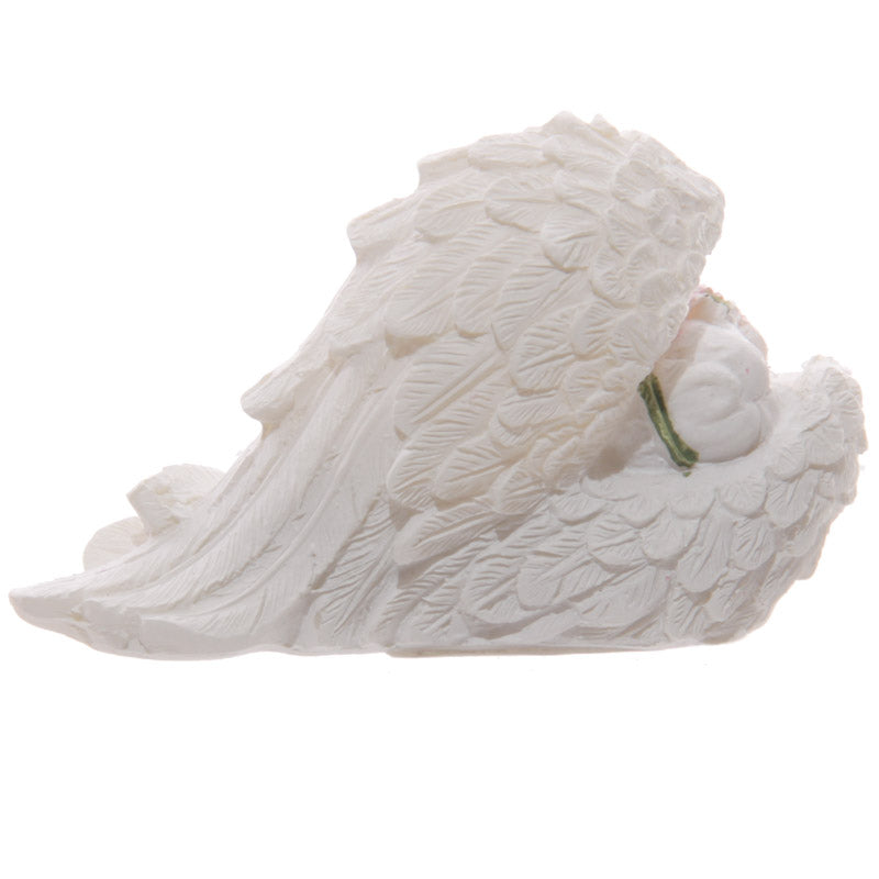 Charming cherub figurine resting among roses