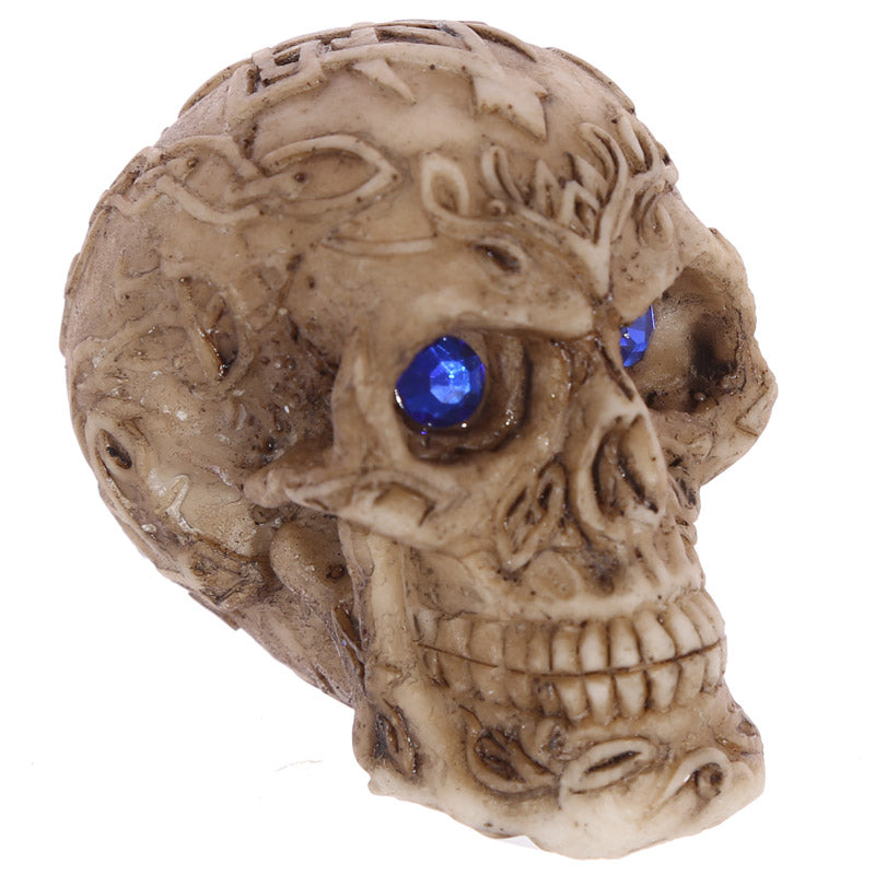 Mini Gothic Skull Decoration with Gem Eyes on a shelf
