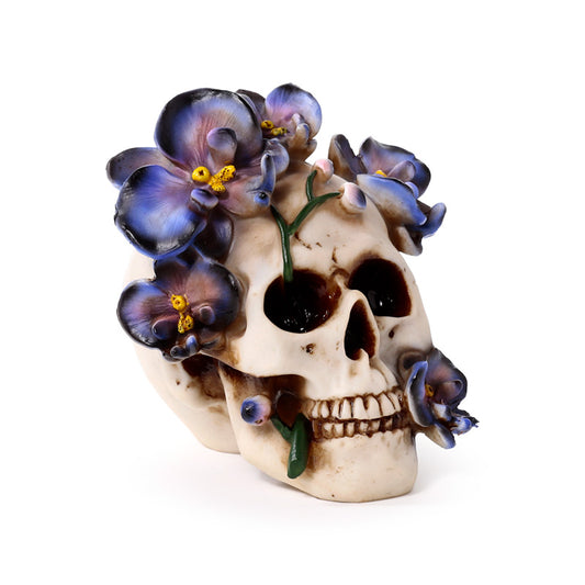 Decorative skull ornament with purple vine flowers
